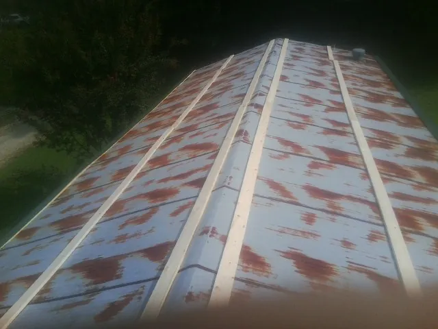 Rusted metal roof panels with new wood purlins before replacement — Storm Damage Roof Repair in Collegeville by Roofing Brothers